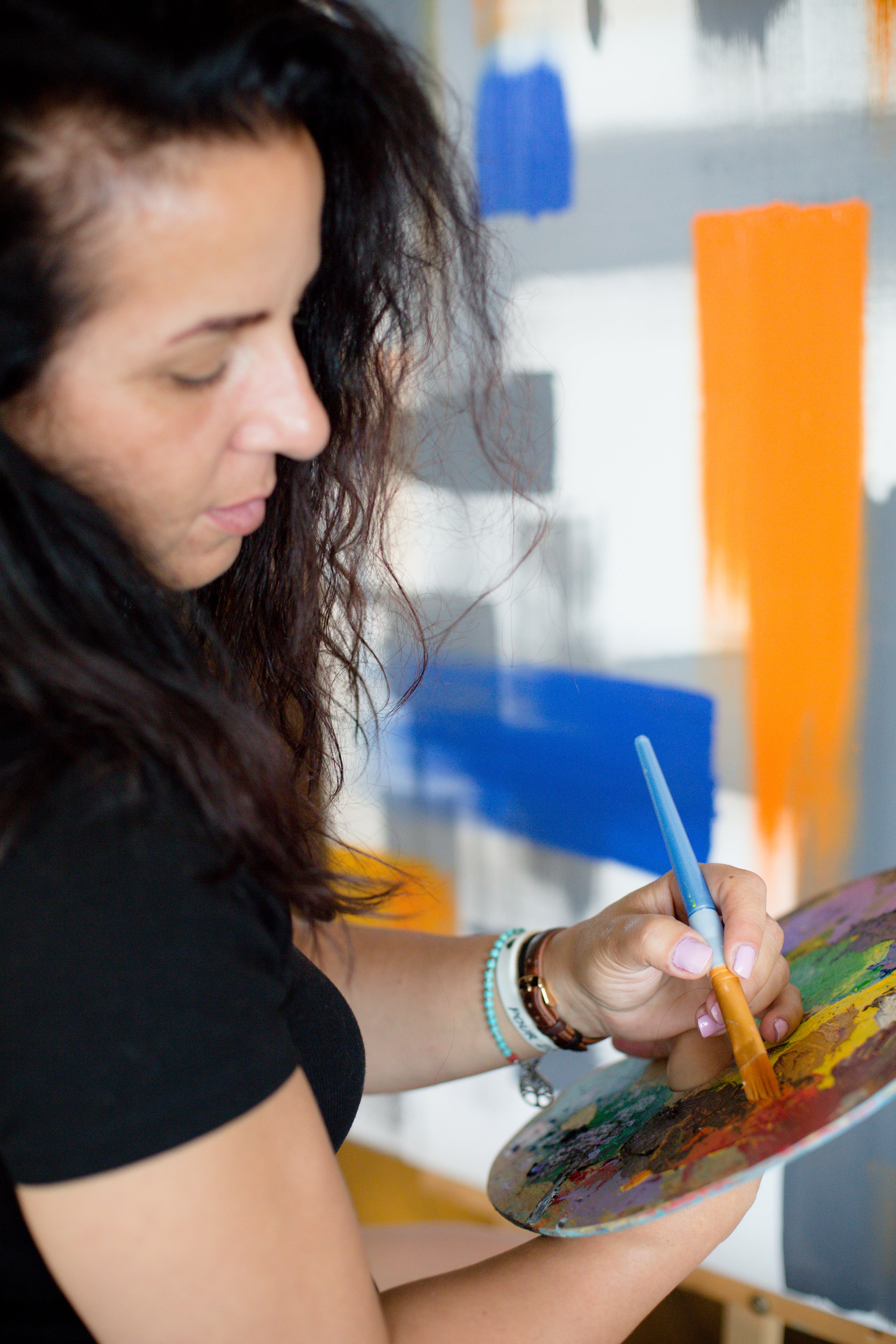 files/person-holds-brush-to-a-pallet-while-painting.jpg